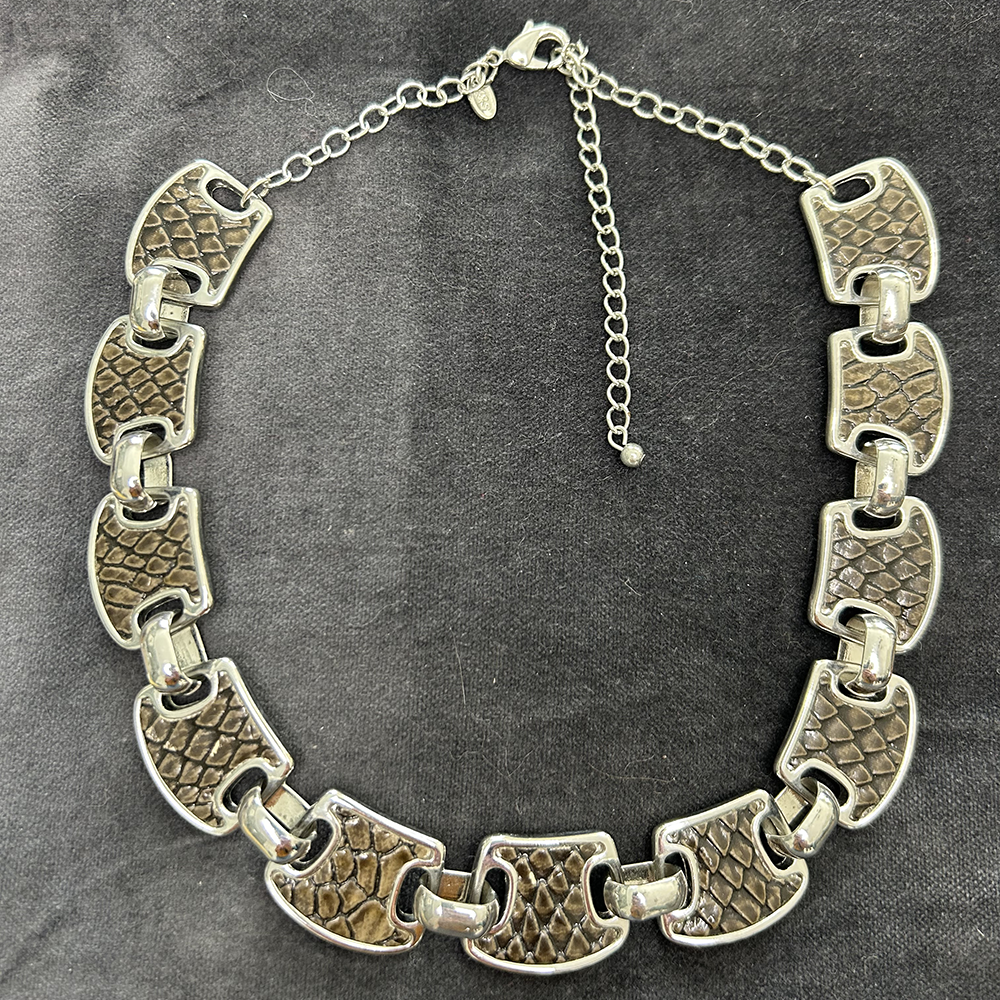 Retro silver coloured necklace with snake effect panels