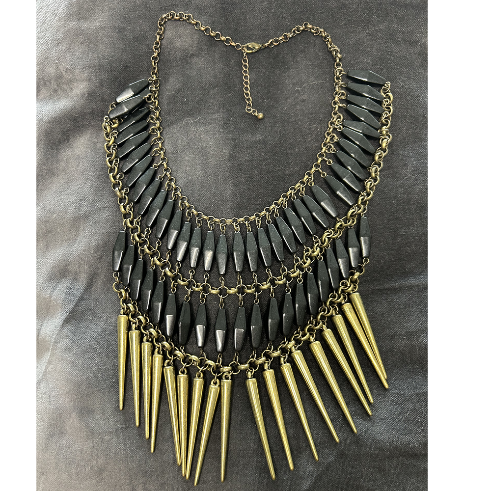 Statement brass and black coloured necklace