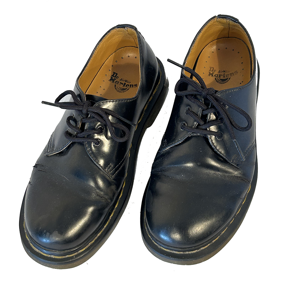 Black leather Dr Martens shoes.